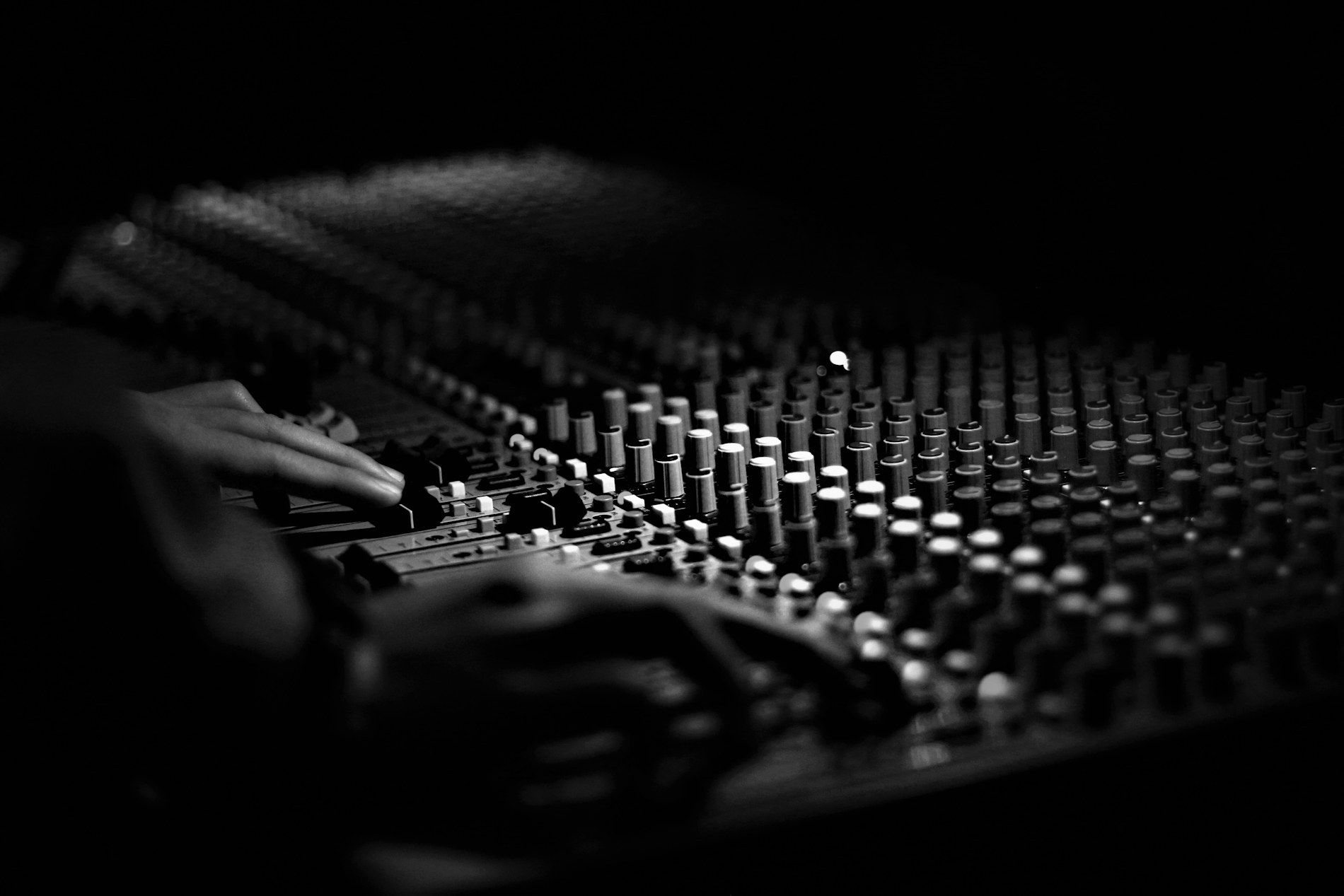 Technician operating an audio mixing desk